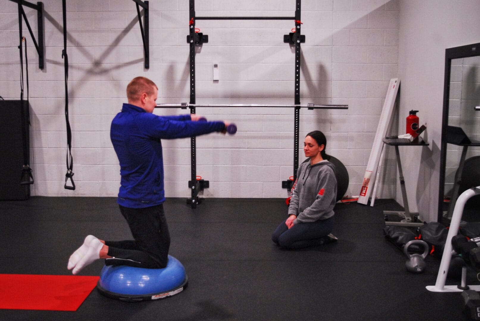 man lifting weight with personal trainer